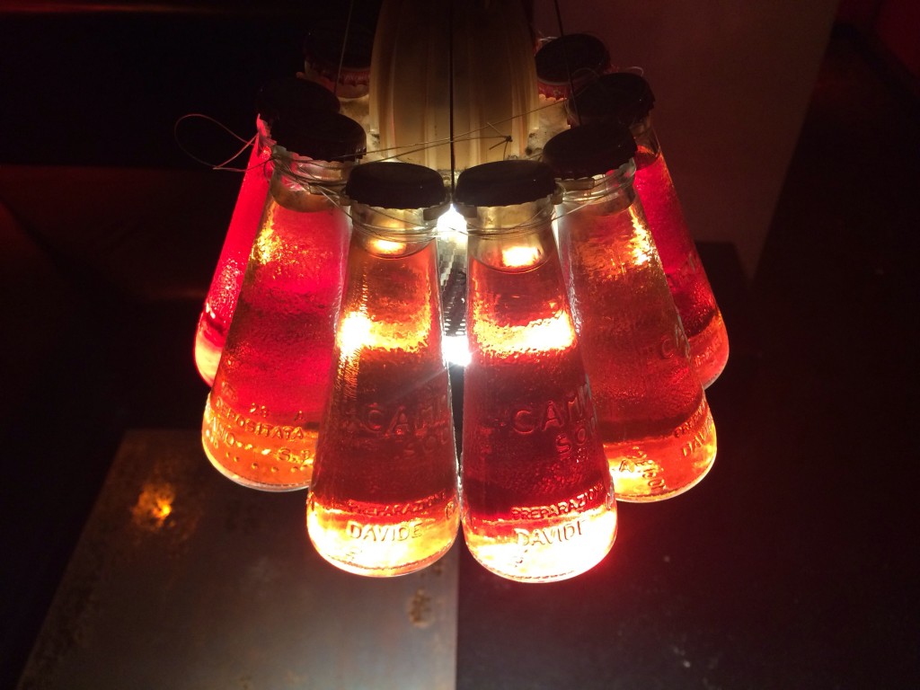 Light fixture made from campari bottles in Negroni