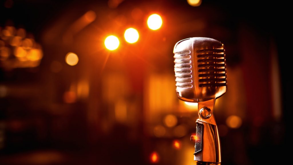 Retro microphone on stage in restaurant. Blurred background